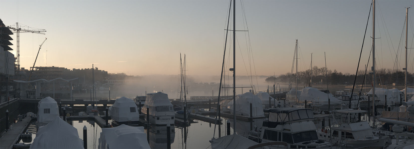 Dawn Over Marina, With Construction to Left, and Radiation Fog Over Water in Background.